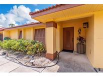 Inviting front entrance with a well-maintained landscape and a charming, covered porch at 5053 Maui Cir # 14, Orlando, FL 32808