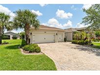 Charming single Gathering home with a three car garage and brick paved driveway at 1306 Harbor Ridge Dr, Kissimmee, FL 34759