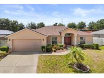 Charming single-story home with a well-manicured lawn and inviting front entrance at 131 Highland Meadows Pl, Davenport, FL 33837