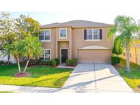 Charming two-story home with a well-manicured lawn, lush landscaping, and a welcoming front entrance at 156 Bristol Forest Trl, Sanford, FL 32771