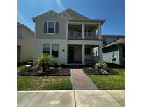 Charming two-story home featuring a welcoming front porch and well-manicured landscaping at 15929 Moonlight Bay St, Winter Garden, FL 34787