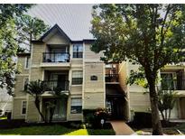 Attractive condo building featuring balconies and well-maintained landscaping, offering a welcoming exterior at 1948 Lake Atriums Cir # 115, Orlando, FL 32839