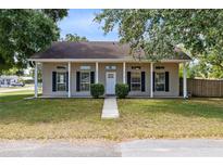 Charming single-story home with a covered porch and well-manicured lawn at 2401 8Th St, St Cloud, FL 34769
