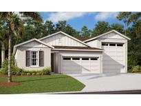 A charming new home with a three-car garage, lush lawn, and beautiful landscaping creates great curb appeal at 331 Alexandrite St, Deland, FL 32720