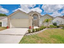Charming single Gathering home with brick accents, manicured landscaping, and inviting front entrance at 3886 Creek Bed Cir, St Cloud, FL 34769