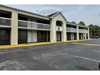 Motel exterior featuring balconies, a large parking area, and easy access to rooms at 5245 W Irlo Bronson Memorial Hwy # 276, Kissimmee, FL 34746