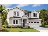 Charming two-story home featuring stone accents, a two-car garage, and a well-manicured lawn at 1058 Cloud Ridge Ct, Mount Dora, FL 32757
