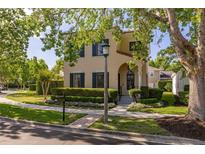 Charming two-story home with a well-manicured lawn and beautiful landscaping at 1116 Oak Pond Dr, Celebration, FL 34747