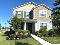 Charming two-story home with well-manicured landscaping and a welcoming front entrance at 11688 Founders St, Orlando, FL 32832