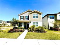 Charming two-story home with well-manicured lawn and lush landscaping at 11688 Founders St, Orlando, FL 32832