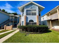Charming condo with light blue siding, brick accents, and well-maintained landscaping at 2714 Rio Grande Trl # 2714, Kissimmee, FL 34741