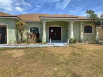 Charming single-story home featuring an inviting front porch and neat landscaping, enhancing its curb appeal at 3329 Winchester Estates Cir, Lakeland, FL 33810