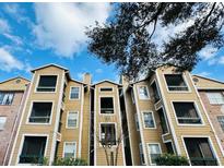 Charming exterior of a condo complex with wood facade and ample windows at 4301 Lizshire Ln # 306, Orlando, FL 32822