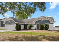 Charming single Gathering home featuring a well-manicured lawn and two car garage at 5512 Hamlin Close, Davenport, FL 33896