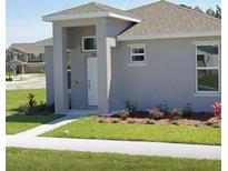 Charming single story home with manicured lawn and inviting front porch area at 5624 Beggs Rd, St Cloud, FL 34771