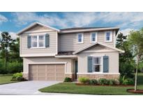 Charming two-story home featuring a stone accent base, a two-car garage, and lovely landscaping at 6413 Clover St, Lake Hamilton, FL 33851