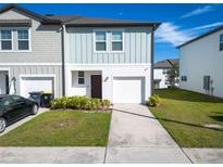 Charming home showcasing a well-manicured lawn, a one-car garage, and a welcoming facade at 740 Madison Dr, Davenport, FL 33837