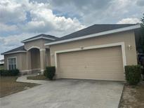 Charming single-story home with a two-car garage and well-maintained front yard at 913 Gascony Ct, Kissimmee, FL 34759
