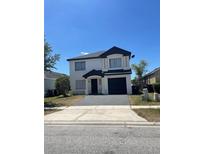 Charming two-story home with a well-maintained front yard and a paved driveway leading to an attached garage at 1211 Carey Glen Cir, Orlando, FL 32824