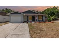 Charming single-story home featuring a well-maintained lawn and a one-car garage at 1622 Crystalview Trl, Lakeland, FL 33801
