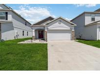Charming single-story home featuring a well-manicured lawn and a two car garage at 2281 Canyon Breeze Ave, Kissimmee, FL 34746