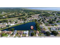 Stunning aerial view of a lakeside home nestled in a tranquil community with lush green surroundings and serene water views at 3928 Blackberry Cir, St Cloud, FL 34769