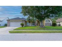 Charming single-story home with brick accents, a well-manicured lawn, and mature landscaping at 3928 Blackberry Cir, St Cloud, FL 34769
