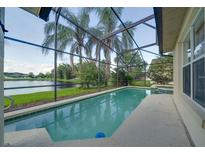 Relaxing screened-in pool with lovely lake views, perfect for enjoying the Florida sunshine at 3928 Blackberry Cir, St Cloud, FL 34769