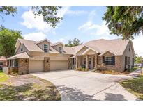 Charming home featuring a brick and siding exterior, a spacious driveway, and a well-manicured lawn at 430 Bywater Dr, Orlando, FL 32839
