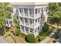 Beautiful condo building with a charming design, featuring multiple balconies and well-maintained landscaping at 7505 Mourning Dove Cir # 201, Reunion, FL 34747