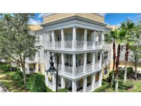 Stunning three-story condo building featuring elegant balconies and classic architectural details at 7509 Mourning Dove Cir # 201, Reunion, FL 34747