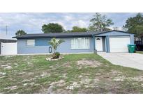 Charming single-story home with a blue exterior, manicured lawn, and attached garage at 31 S Edgemon Ave, Winter Springs, FL 32708
