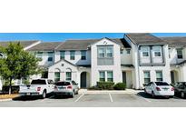 Well-maintained townhomes feature neutral paint, decorative trim, and convenient parking at 349 Captiva Dr, Davenport, FL 33896