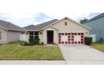 Charming single-Gathering home with manicured lawn and a two-car garage in a suburban neighborhood at 3690 Maidencain St, Clermont, FL 34714