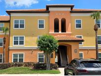 Charming multi-story condo building with a terracotta roof, stylish architecture, and well-maintained landscaping at 5451 Vineland Rd # 111, Orlando, FL 32811