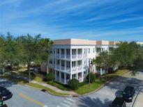 Stunning building with multiple levels, complemented by lush landscaping, and beautiful balconies at 7503 Mourning Dove Cir # 101, Reunion, FL 34747