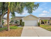 Charming single-story home featuring a two-car garage and a well-maintained front yard with mature landscaping at 7807 Turkey Oak Ln, Kissimmee, FL 34747