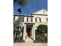 Charming two-story townhouse with a welcoming front porch and well-maintained landscaping at 8271 Maritime Flag St # 109, Windermere, FL 34786