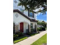 Charming two-story home with a red front door and stone accents, offering appealing curb appeal at 9938 Eagle Creek Center Blvd, Orlando, FL 32832