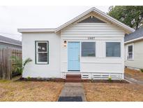 Quaint single-story home with a light blue front door, freshly painted white exterior, and new landscaping at 1007 11Th St, St Cloud, FL 34769