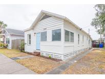 Charming home featuring a new paint job, blue door, landscaping, and well-maintained lawn at 1007 11Th St, St Cloud, FL 34769