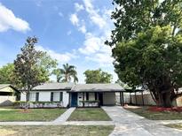 Charming single-story home featuring black shutters, fresh landscaping, and a convenient covered carport at 1098 Leeway Ct, Orlando, FL 32810