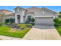 Charming single-story home featuring a well-manicured lawn and attached two-car garage at 12313 Prairie Plantation Way, Orlando, FL 32824