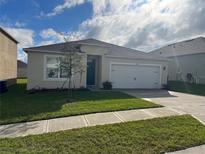 Inviting single-Gathering home with a well-manicured lawn and an attached two-car garage at 1828 Buckeye Rd, Davenport, FL 33837