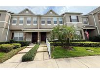 Charming townhome featuring manicured landscaping, stone accents, and a welcoming front entrance at 2287 Park Maitland Ct, Maitland, FL 32751