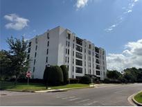 Modern condo building featuring multiple floors, black framed windows, and meticulously maintained green landscaping at 265 E Canton Ave # Ge, Winter Park, FL 32789