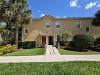 Charming condo with lush landscaping, sidewalk, and a well-maintained exterior, offering a welcoming curb appeal at 2736 Oakwater Dr, Kissimmee, FL 34747