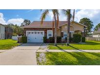 Charming single-story home with a stone facade, two-car garage, and well-maintained landscaping at 2902 Paddington Way, Kissimmee, FL 34747