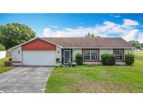 Charming single-story home with a well-maintained lawn and attached two-car garage at 3110 Short Leaf Pine Ct, Kissimmee, FL 34746