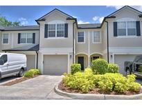 Charming townhome featuring a two-car garage and inviting landscaping at 3151 Sinclair St # 104, Orlando, FL 32835